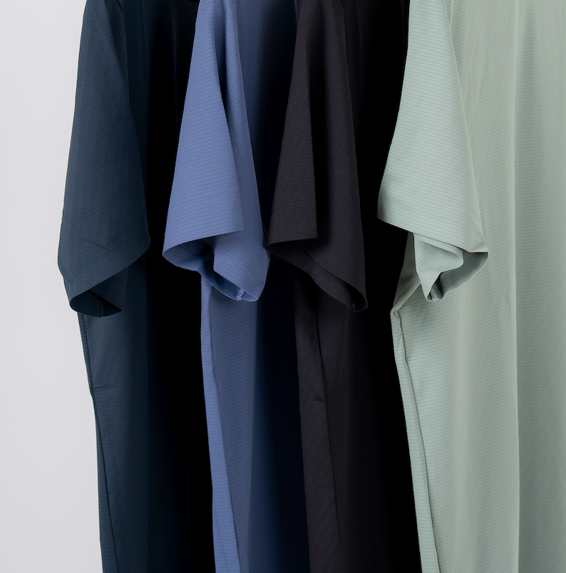close up of four short sleeve lightweight mens t-shirts in the colors celadon, grey, charcoal and black made out of premium lightweight fabric for athletic fit designed for every training session.
